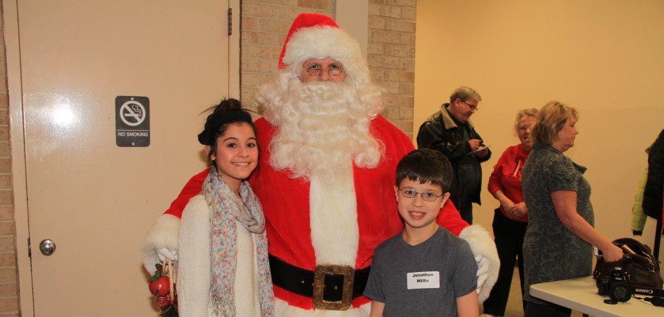 Children with Santa at the Ruth Sokolof Christmas Party